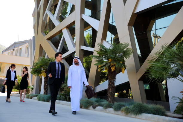 Business professionals walking outside a modern building in KIZAD Free Zone, discussing commercial opportunities.